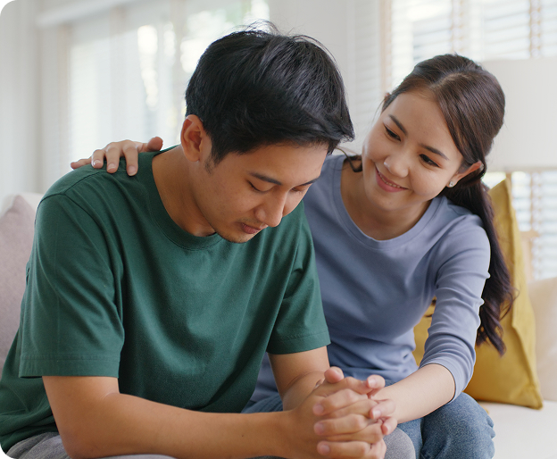 A woman comforting a man