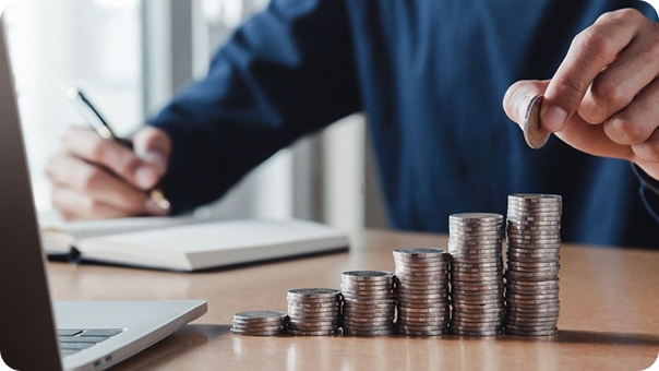 A man writing while arranging coins